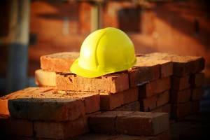 Under construction, helmet and bricks for building site