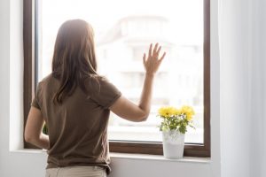 woman-quarantine-home-looking-through-window_23-2148740979