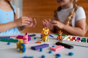 kids-playing-with-play-dough_23-2149572091